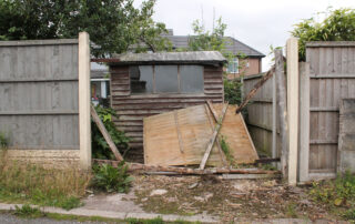 broken garden shed and fence