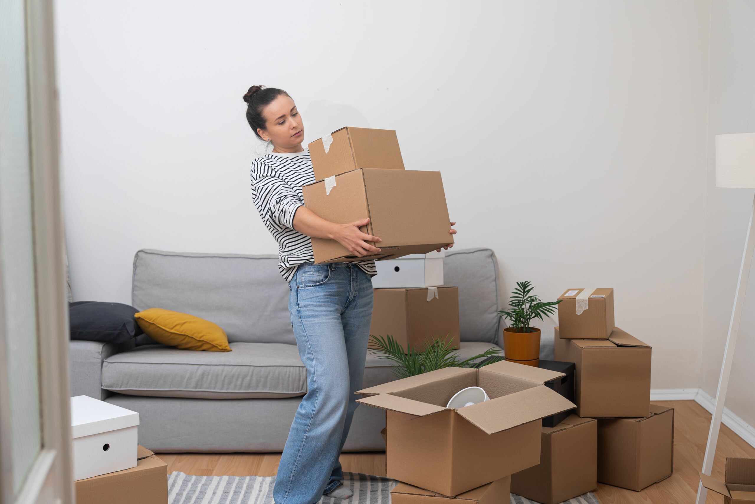 Young woman with boxes moving into new home.